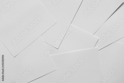 Heap of scattered white empty clean blank paper sheets. Top view, horizontal. Template for posters. Mockup placards