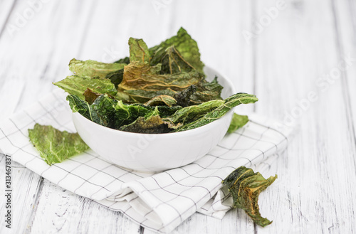 Some Savoy Chips on a vintage wooden table (selective focus; close-up shot)