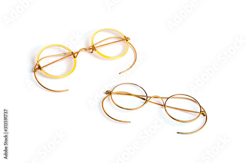 Couple of golden old fashion glasses isolated on white background