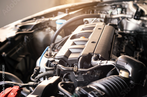 details of modern car engine with sunlight effect, shallow depth of field, internal combustion engine vehicle