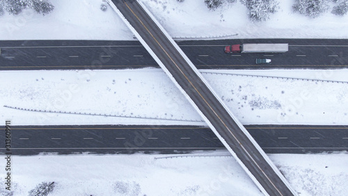 TOP DOWN: Flying above a highway overpass in USA during an intense blizzard.