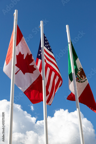 Flags of United States, Mexico, Canada fluttering in the sky