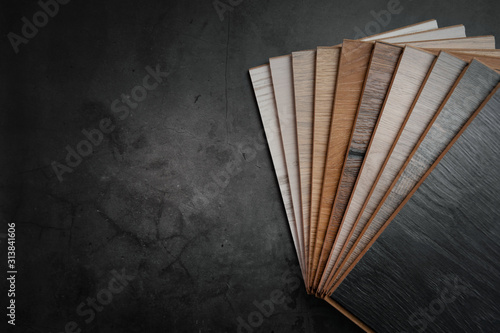 wood texture laminate material samples on black stone background with copy space