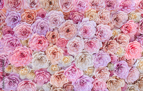 Colorful paper flowers in the form of a large background for decorating wedding ceremonies, photo zones and romantic photo shoots. The concept of spring flowering.