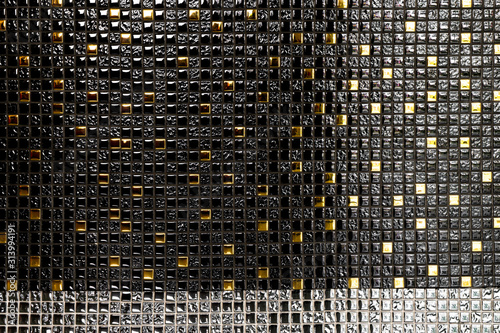 Luxury black and golden mosaic tiles on the wall for interior or decoration in room.