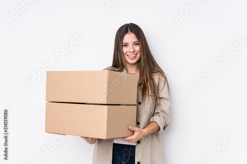 Young caucasian woman moving to a new home laughing and having fun.