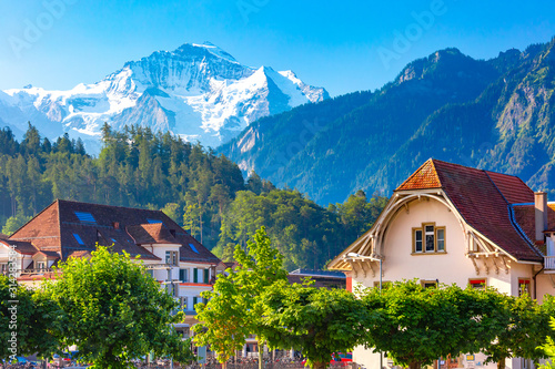Houses in Old City of Interlaken, important tourist center in the Bernese Highlands, Switzerland. The Jungfrau is visible in the background