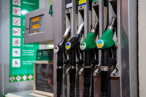 Gasoline and diesel distributor at the gas station. Gas pump nozzles. Petrol filling gun close-up at the gas station. Colorful Petrol pump filling nozzles. Fuel pump