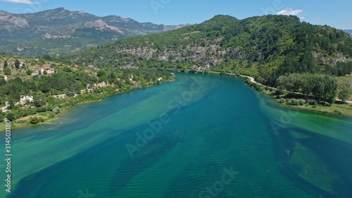 Aerial view of Trebisnjica river mountainous valley, Lastva village, Bosnia and Herzegovina. Turquoise water, green hills.