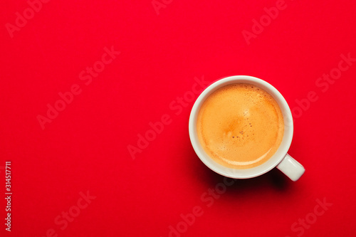 Black coffee in a cup on a red background