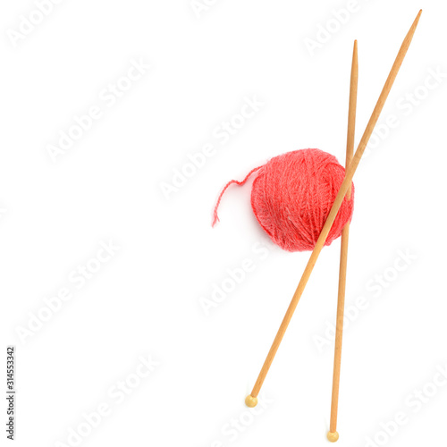 Ball of woolen thread and knitting needles isolated on white background. Free space for text.