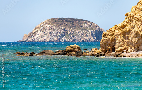 Gravel / pebble beach Akra Fourni nearby Monolithos at Rhodes island with multi colored ocean water and rocks