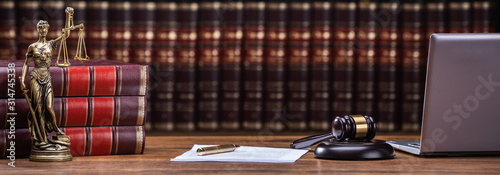 Mallet And Legal Book With Justice Scale On Table