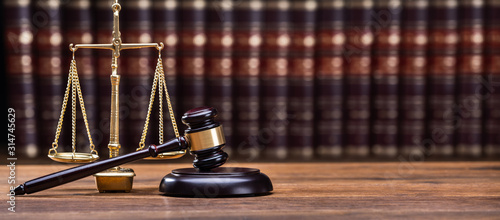 Gavel In Front Of Books With Golden Scale