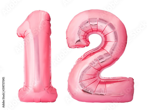 Number 12 twelve made of rose gold inflatable balloons isolated on white background. Pink helium balloons forming 12 twelve number