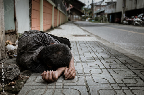 hands poor man or beggar begging you for help sitting at dirty slum. concept for poverty or hunger people,human rights,donate and charity for underprivileged children in third world 