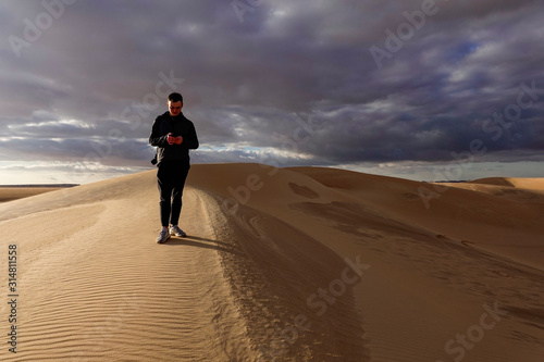 Siwa Oasis, Egypt A man walks on the sand dunes outside the oasis.