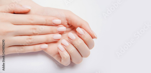 Stylish trendy nail young woman hands pink manicure on white background