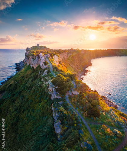 View from flying drone. Aerial spring view of Milazzo lighthouse. Gorgeous morning scene of Milazzo peninsula. Stunning sunrise on Sicily, Italy, Europe. Beauty of nature concept background.