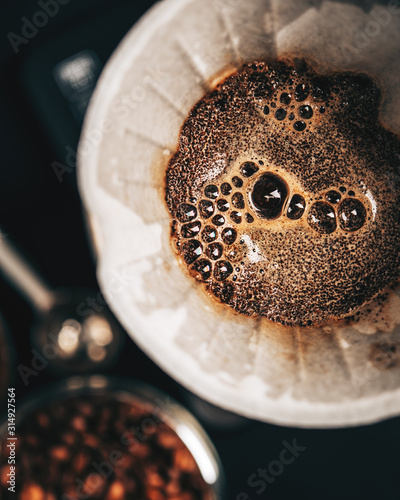 The process of making coffee by the alternative method of purover, paper filter, top view,dark background