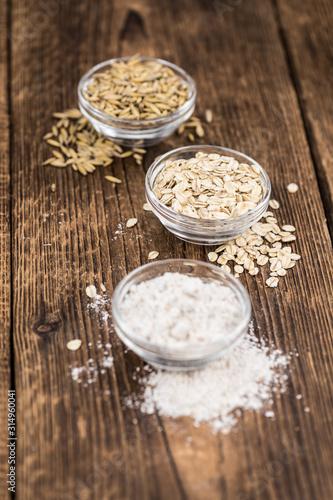 Some fresh Oat Flour on wooden background (selective focus; close-up shot)