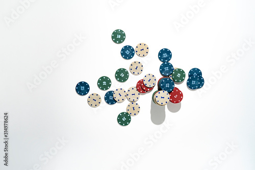 top view bunch of poker chips drop on colorful table, winning the holdem in casino, minimalist