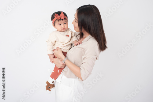 Asian mother and adorable baby girl are happy on white background