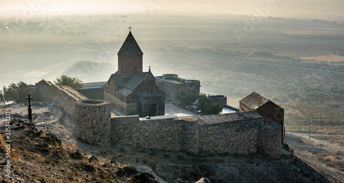 Khor Virap an Armenian monastery located in the Ararat plain in Armenia, near the closed border with Turkey, panoramic view during autumn sunrise with fog on background