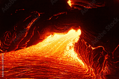 Detailed view of an active lava flow, hot magma emerges from a crack in the earth, the glowing lava appears in strong yellows and reds - Hawaii, Big Island, Kilauea volcano, Kalapana