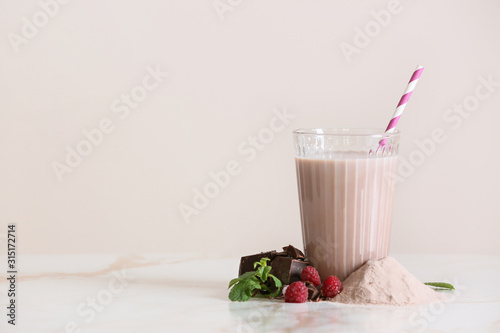 Glass of protein shake on light table