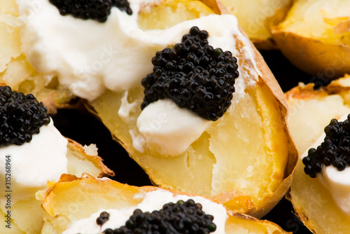 Baked potato with spiced cream cheese and caviar