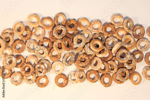 Bublik cookies pattern. Pile of ring shaped roll cookies with different glaze..