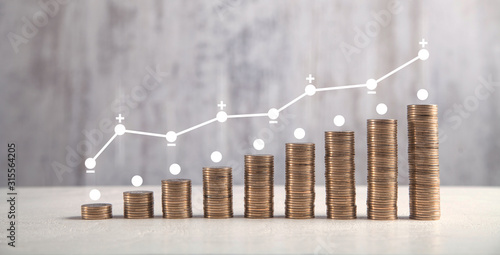  Coins on white table with profit graph.