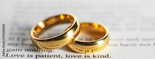 Golden wedding rings on bible book