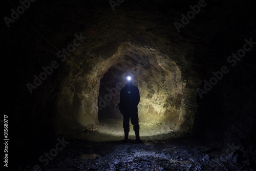 Underground gold mine shaft tunnel drift with miner