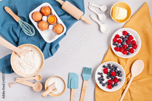 Rustic baking ingredients and kitchen utensils. Homemade pastry, baking. Top view flat lay background. Copy space. Healthy fresh organic food.