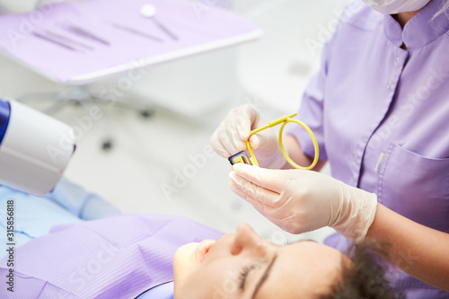 Dental assistant prepares the dental X-ray