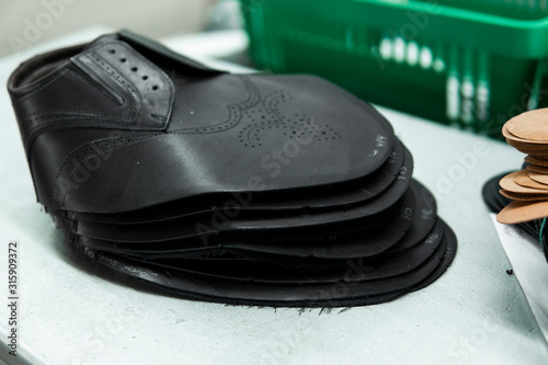 Stitched shoes without soles at the shoe factory. Prepared, bundled leather parts, used in the production of shoes.