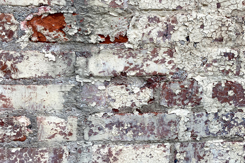 white pealing paint red brick wall