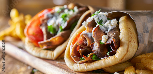 two tasty wrapped greek lamb gyros