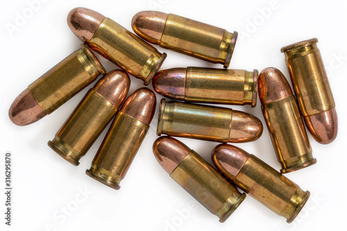 Pile of 9mm bullets on a white background. Image