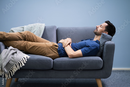 Man Sleeping On Sofa At Home