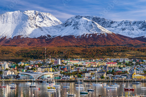 Colorful scene view of the bay and Ushuaia city against snow-capped Andes mountains during autumn season, Tierra del Fuego, Patagonia, Argentina