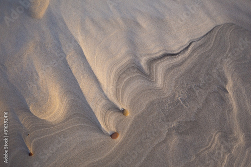 Beautiful patterns created by the wind on the beach in the Slowinski National Park. Czolpino, Leba, Poland.