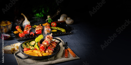 Shish kebab with various vegetables and spice country potatoes