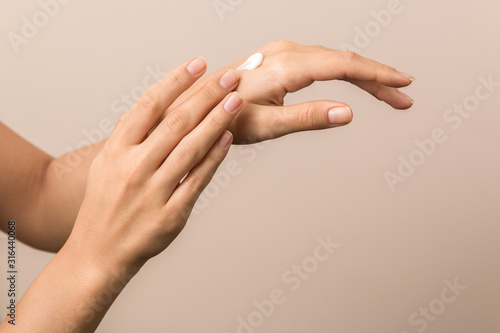 healthy hands of a young woman applying the cream. skincare concept beauty photoshoot
