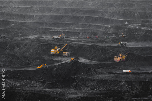 Open pit mine, coal loading in trucks, transportation and logistics