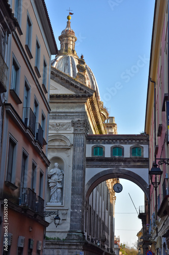 Capua, Italy, 01/12/2020. A clock on an arch in a street of the town