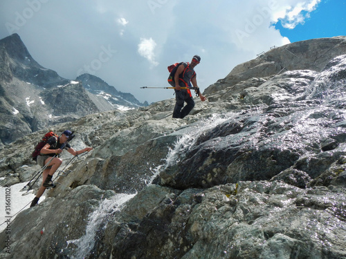 two men in the high way of adamello glacier