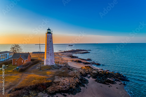 Lighthouse and Oyster Boat at Sunrise on New Haven Harbor